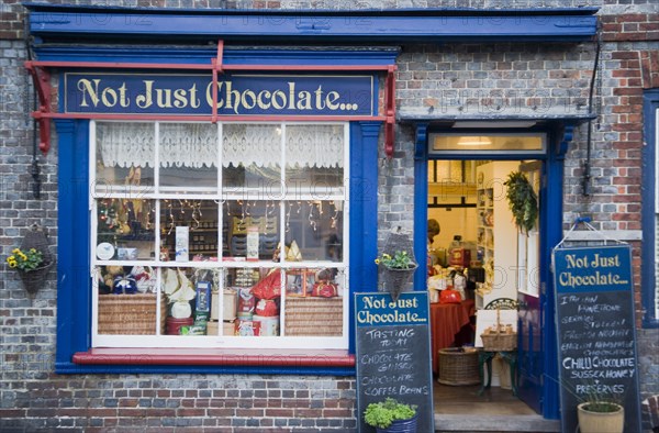 ENGLAND, East Sussex, Alfriston, Not Just Chocolate confectionary shop opposite the market cross.