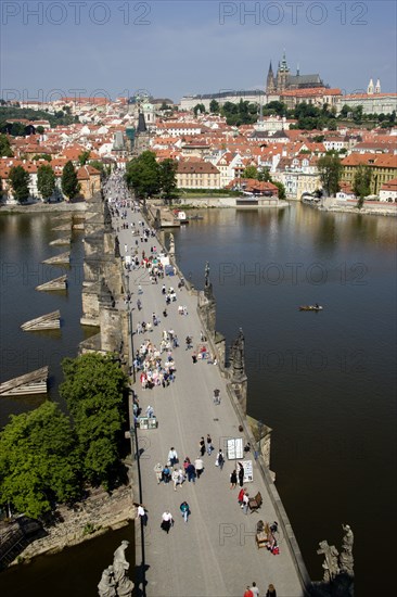 CZECH REPUBLIC, Bohemia, Prague, People walking across the Charles Bridge across the Vltava River towards the Little Quarter