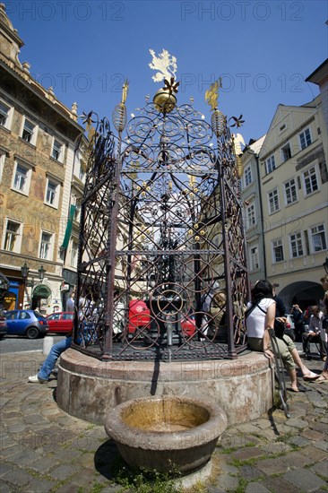 CZECH REPUBLIC, Bohemia, Prague, Old Town.Tourists around a water fountain with ornate metalwork in Male Namesti