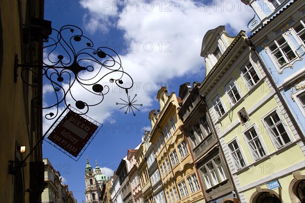 CZECH REPUBLIC, Bohemia, Prague, The Little Quarter Renaissance and Baroque buildings in Bridge Street with an ornate Pizza sign hanging over the street