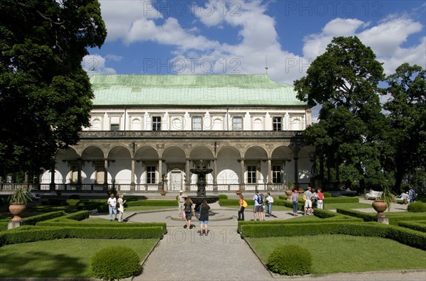 CZECH REPUBLIC, Bohemia, Prague, Tourists in the gardens around the Singing Fountain in front of the Belvedere or Royal Summer Palace in the Italian Renaissance style built by King Ferdinand I for his wife Anne