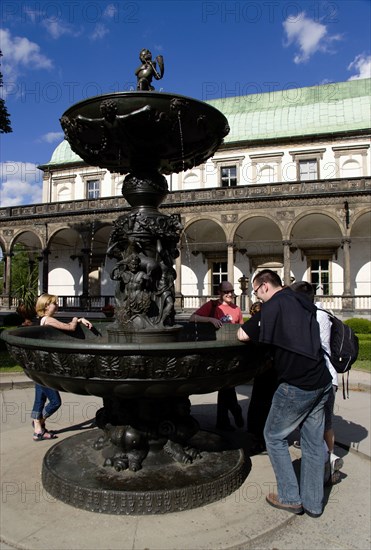 CZECH REPUBLIC, Bohemia, Prague, Tourists at The Singing Fountain in front of the Belvedere or Royal Summer Palace in the Italian Renaissance style built by King Ferdinand I for his wife Anne
