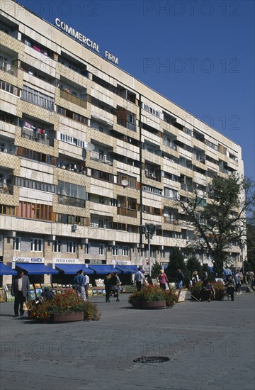 KAZAKHSTAN, Almatr, Street scence with people selling paintings in front of shops and apartrments.