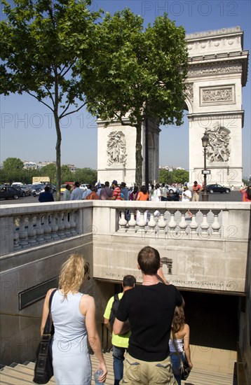FRANCE, Ile de France, Paris, Tourists entering the pedestrian tunnel under the Place de Charles de Gaullle leading to the Arc de Triomphe