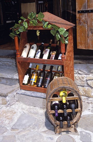 BULGARIA, Veilko Tarnovo, Display of wine bottles outside wine shop.