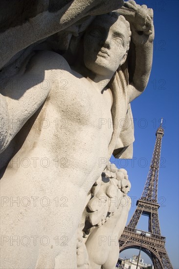 FRANCE, Ile de France, Paris, Stone sculptures in the Jardin du Trocadero with the Eiffel Tower beyond