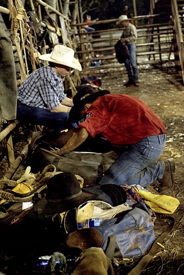 Australia, Northern Territory, Darwin, Darwin Rodeo - Coboys preparing their gear.