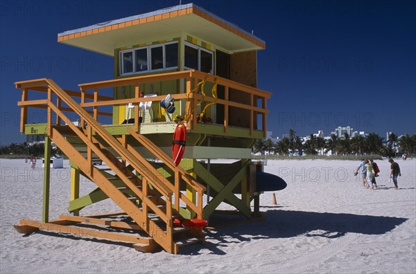 USA, Florida, Miami, South Beach. Ocean Drive. Orange and Green Lifeguard station on sandy beach