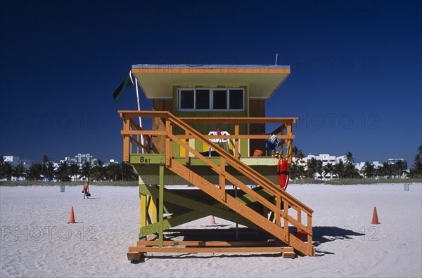 USA, Florida, Miami, South Beach. Ocean Drive. Orange and Green Lifeguard station on sandy beach
