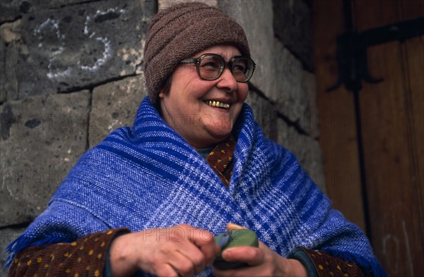 ARMENIA, People, "Portrait of smiling woman wearing blue shawl, hat and glasses and with several gold teeth."
