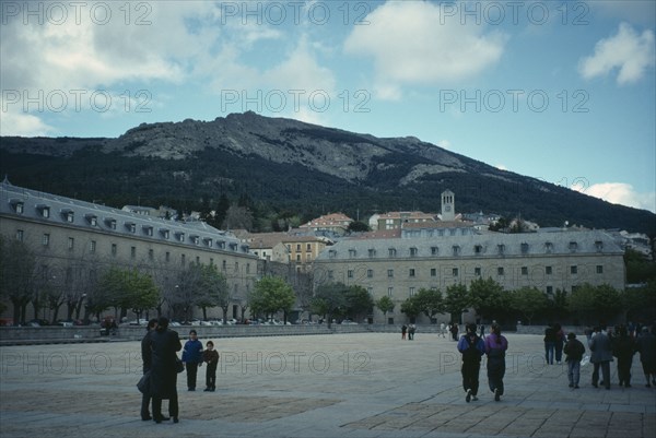 SPAIN, Madrid, El Escorial, Royal Monastery of San Lorenzo de el Escorial.  Sixteenth century palace and monastery built during the reign of Phillip II.  Exterior with tourist visitors in foreground.