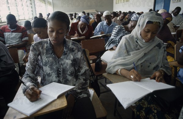 NIGERIA, Kano, Students writing at desks in law school.