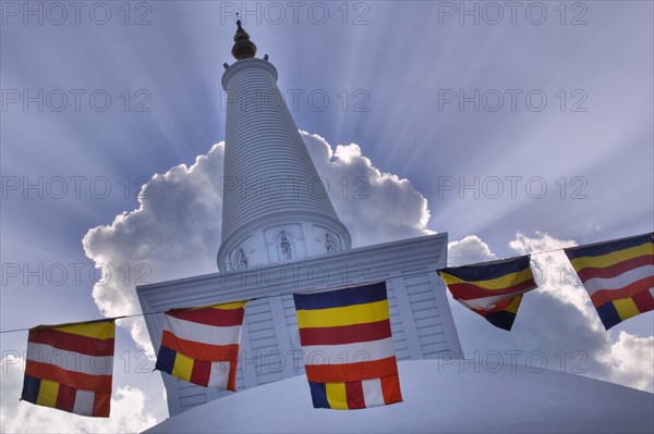 SRI LANKA, Anuradhapura, Prayer flags hanging in front of Ruvanvelisaya Dagoba.