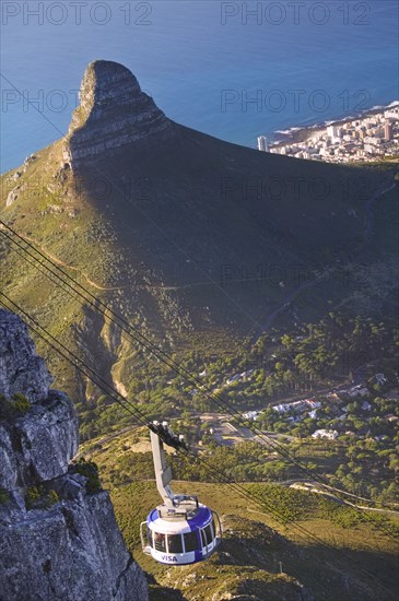 SOUTH AFRICA, Western Cape, Cape Town, Cable car on Table Mountain with the Lion's Head in the background.