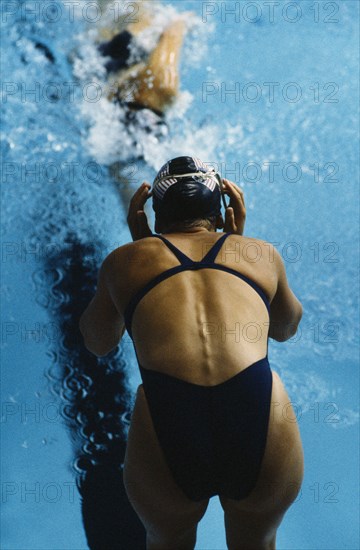 20084745 SPORT Water Sport Swimming USA. World Student Games. Female swimmer in relay changeover