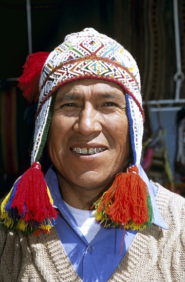 PERU, Cusco, "Peruvian man wearing colourful traditional hat with tassels, in Mercado del Quiswarcancha."