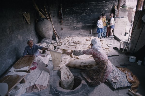 ARMENIA, People, Cooking, Women baking traditional flat bread or lavash also known as Armenian Cracker Bread.