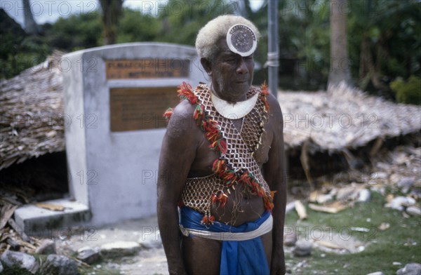 PACIFIC ISLANDS, Melanesia, Solomon Islands, "Malaita Province, Lau Lagoon, Funafou Artificial Island.  Three-quarter standing portrait of priest, Ratu.  "