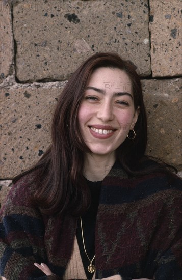 ARMENIA, People, "Head and shoulders portrait of smiling young woman with long, dark hair."