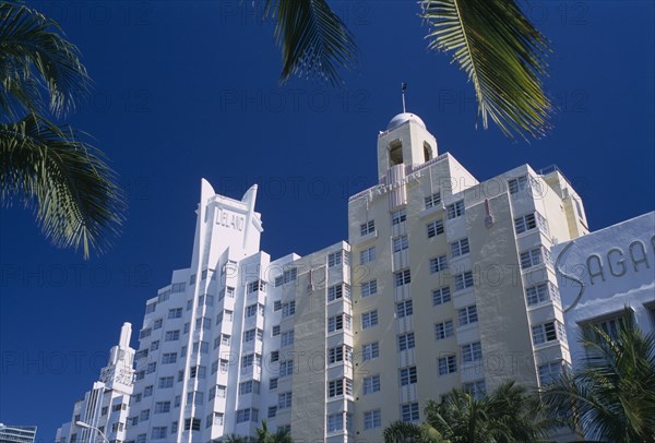 USA, Florida, Miami, "South Beach. Collins Avenue. The Delano, The National and The Sagamore Hotel facades framed by palm tree branches"