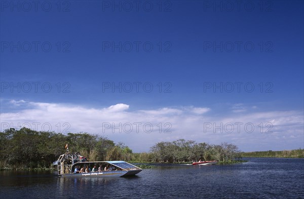 USA, Florida, Fort Lauderdale, Tourists Air boating in the Everglades National Park