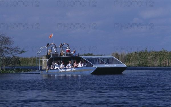 USA, Florida, Fort Lauderdale, Tourists Air boating in the Everglades National Park