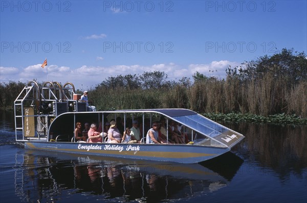 USA, Florida, Fort Lauderdale, Tourists Air boating in the Everglades National Park