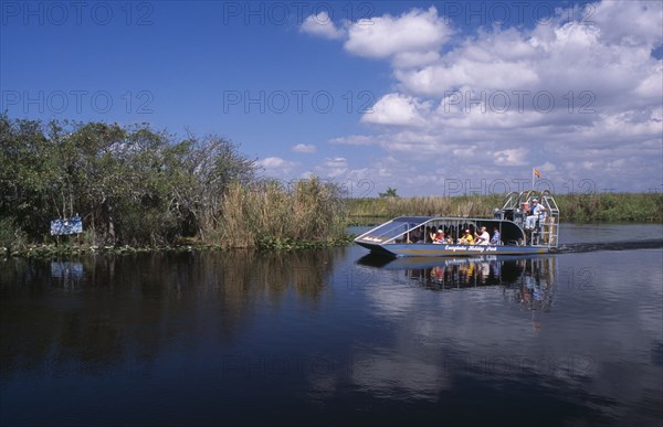 USA, Florida, Fort Lauderdale, Tourists Air boating in the Everglades National Park