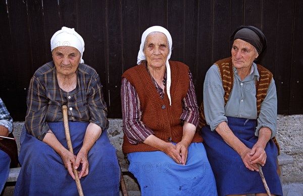 BULGARIA, Bansko, Three old ladies sitting on bench