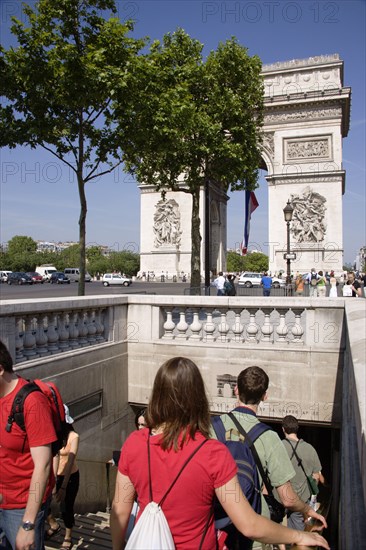 FRANCE, Ile de France, Paris, Tourists entering the pedestrian tunnel under the Place de Charles de Gaullle leading to the Arc de Triomphe