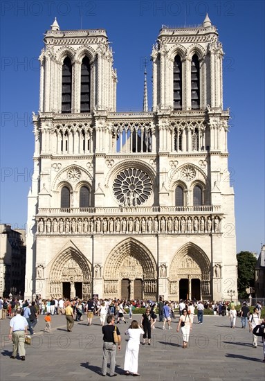 FRANCE, Ile de France, Paris, Tourists in the Place du Parvis Notre Dame in front of the west front of the Gothic Cathedral of Notre Dame on the Ile de la Cite