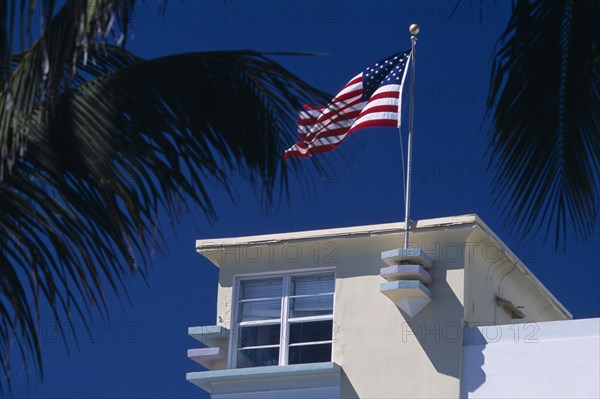 USA, Florida, Miami, South Beach. Ocean Drive. Detail of an Art Deco building with an American flag flying from the roof