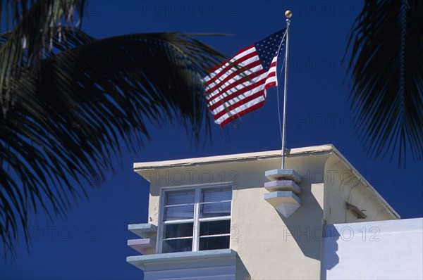 USA, Florida, Miami, South Beach. Ocean Drive. Detail of an Art Deco building with an American flag flying from the roof