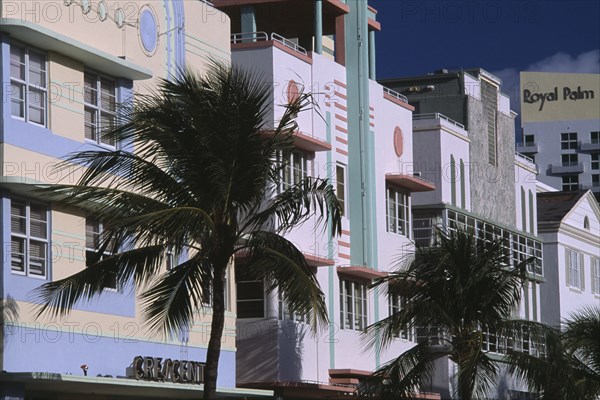 USA, Florida, Miami, South Beach. Ocean Drive. Art Deco hotel facades and palm trees seen in early morning light