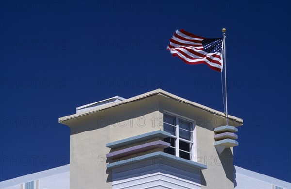 USA, Florida, Miami, South Beach. Ocean Drive. Detail of an Art Deco building with an American flag flying from the roof