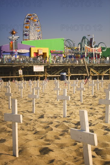 USA, California, Santa Monica, A graphic protest against the war in Iraq beneath Santa Monica Pier. Each white cross represents a member of the American armed forces who has lost their life.