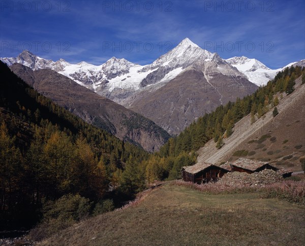 SWITZERLAND, Valais, Ottavan Hamlet , Storage Barns high above Mattertal Weisshorn Mountain 14757ft  ) on west skyline