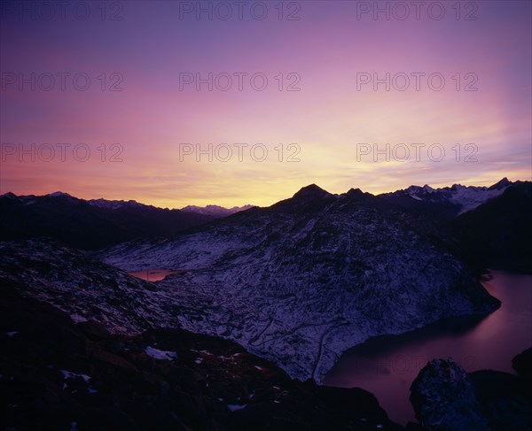 SWITZERLAND, Valais, Grimsel Pass, Sunset over Grimsel Pass. Oberaasee on the left and Grimselsee on the right.