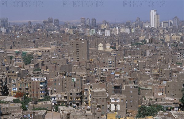 EGYPT, Cairo Area, Cairo, Elevated view over city rooftops with tall buildings on the skyline