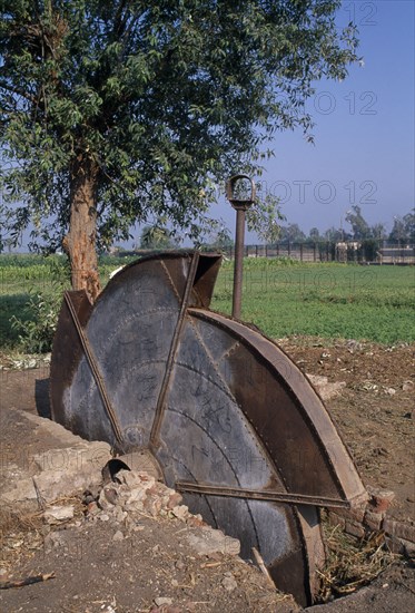 EGYPT, Agriculture , A disused water pump with fields behind