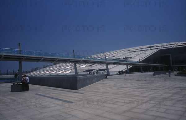 EGYPT, Nile Delta, Alexandria, Bibliotheca Alexandrina modern library exterior with view from complex towards long slender bridge leading to entrance