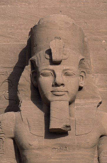EGYPT, Nile Valley, Abu Simbel, Ramses II colossal enthroned statue. Detail of head and upper torso