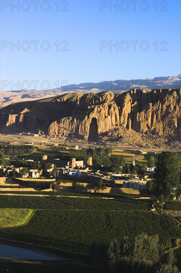 AFGHANISTAN, Bamiyan Province, Bamiyan , View of Bamiyan valley and village showing cliffs with empty niche where the famous carved Budda once stood (destroyed by the Taliban in 2001)
