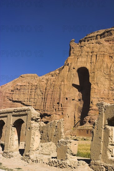 AFGHANISTAN, Bamiyan Province, Bamiyan , Remains of bazzar which was destroyed by the Taliban infront of empty niche where the famous carved Budda once stood (destroyed by the Taliban in 2001)