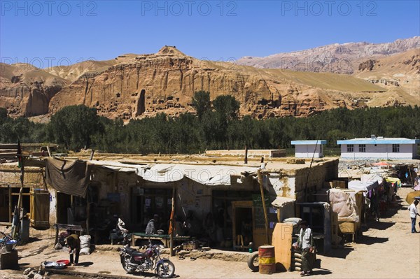 AFGHANISTAN, Bamiyan Province, Bamiyan , Main road in town infront of empty niche in cliffs where the famous carved large Budda once stood 180 foot high before being destroyed by the Taliban in 200