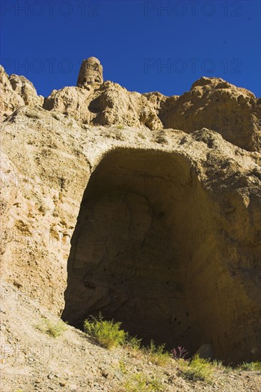 AFGHANISTAN, Bamiyan, Kakrak valley, "Empty niche in which once stood a 21ft standing Buddha, - discovered in 1030 and surrounded by caves whose Buddhists paintings thought to date from the 9th and 9th Centuries AD but removed by French archaeologists and put in the National musuem in Kabul"