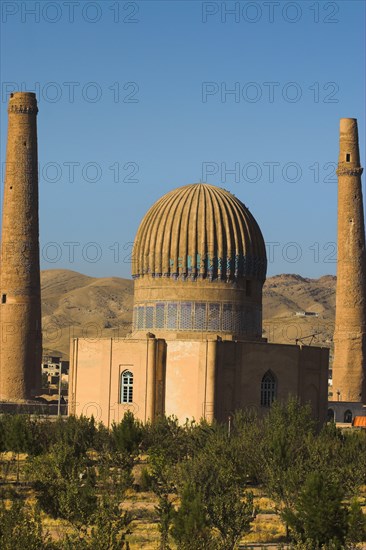 AFGHANISTAN, Herat, "The Mousallah Complex, Gaur Shad 's Mausoleum Part of the Mousallah Complex which included the remains of an old madrassa built by Queen Gaur Shad in 1417, wife of Timurid ruler Shah Rukh, son of Tamerlane,. There were several minarets in this complex but six were demolished by British troops in 1885, 3 were destroyed by earthquakes There are 6 remaining minarets one stands by the mausoleum with a mortar hole in it, another one also near the mausoleum is partly destroyed and four stand marking the corners of the long gone Madrassa built by Sultan Husain Baiquara last of the Timurid rulers "