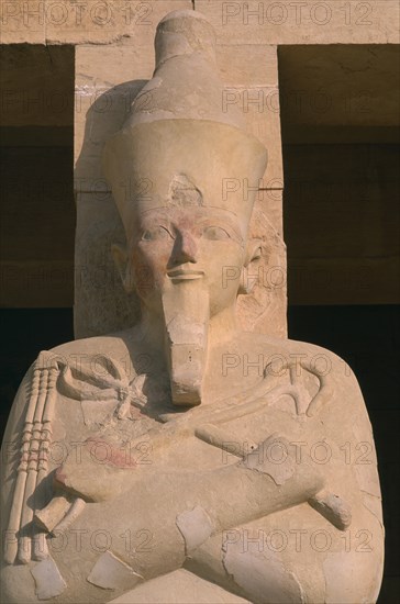EGYPT, Nile Valley, Thebes, Deir-el-Bari. Hepshepsut Mortuary Temple. Hepshepsut statue reprenseted as a male with a beard and crossed arms bearing the crook and flail