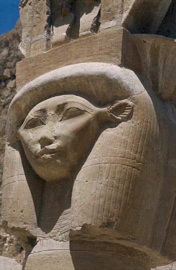 EGYPT, Nile Valley, Thebes, Deir-el-Bari. Hepshepsut Mortuary Temple. Carved column with head of Goddess Hathor represented with cows ears. One of the Hathoric columns.