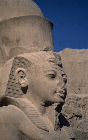 EGYPT, Nile Valley, Thebes, "Deir el-Bahri, Hatshepsut Mortuary Temple. Side profile of defaced statue of female pharaoh Hatshepsut, depicted in masculine form. Her image was defaced after her demise by pharaoh Tuthmosis III, for whom she acted as regent."